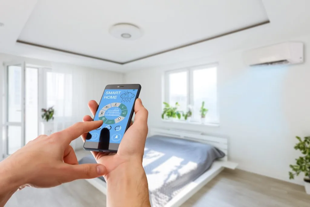 Smartphone controls exterior home lighting in a modern Winnipeg bedroom