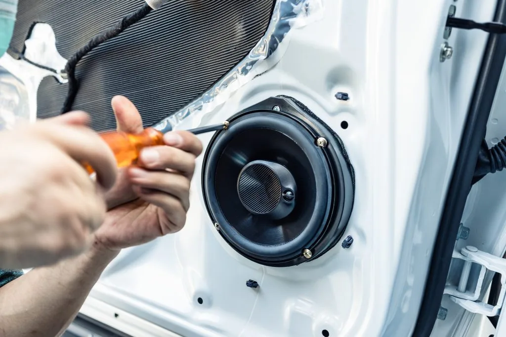 Home automation Winnipeg expert installing a speaker into a vehicle door