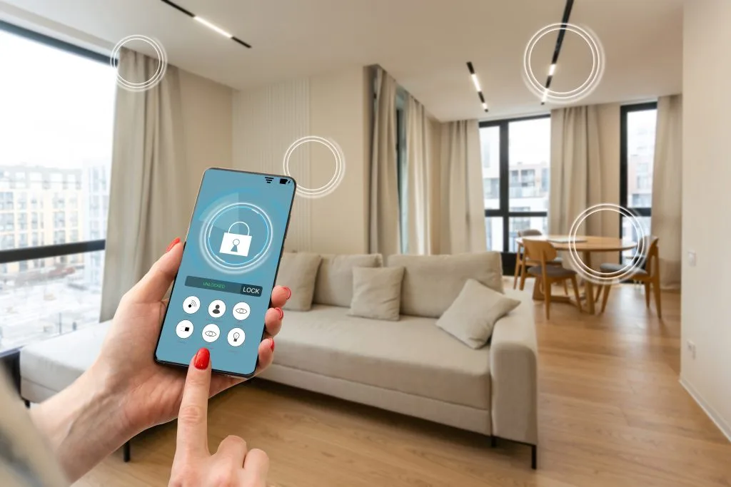 A person interacts with a smartphone displaying a security interface in a modern living room