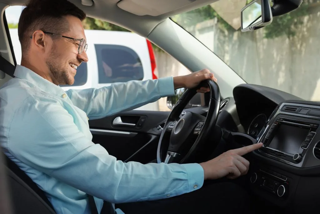 Home automation Winnipeg showcased through a man using a car's touchscreen technology