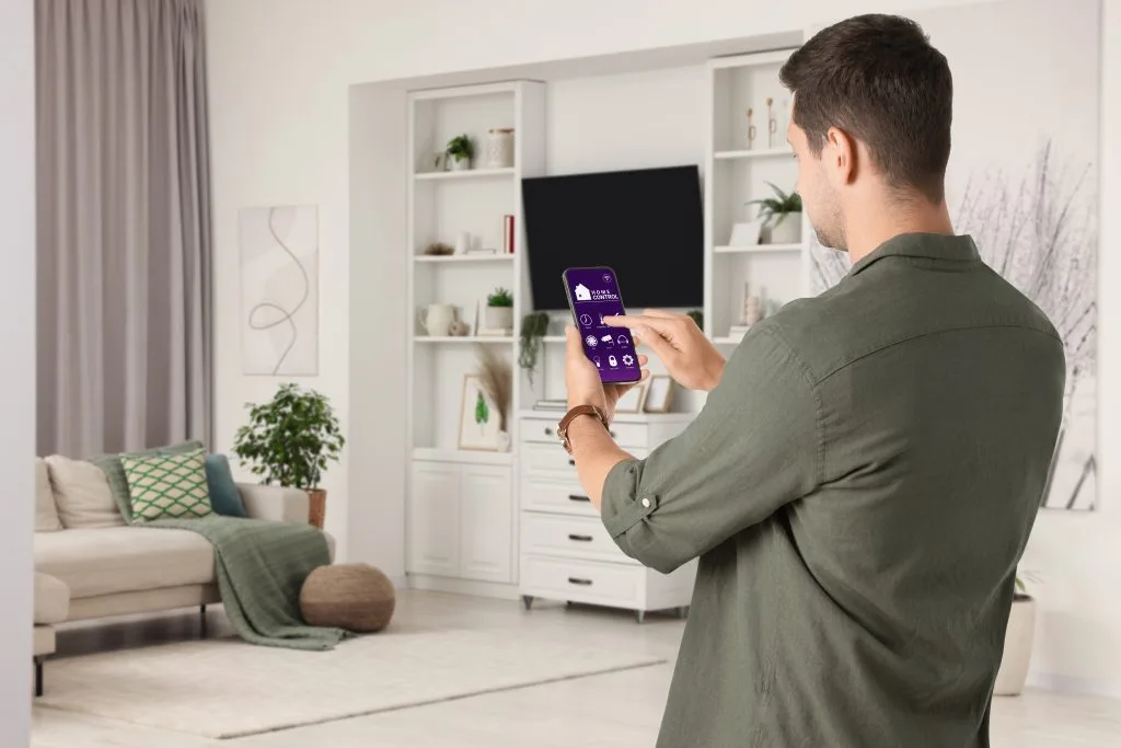 Modern living room with exterior home lighting in Winnipeg showcased through smart technology