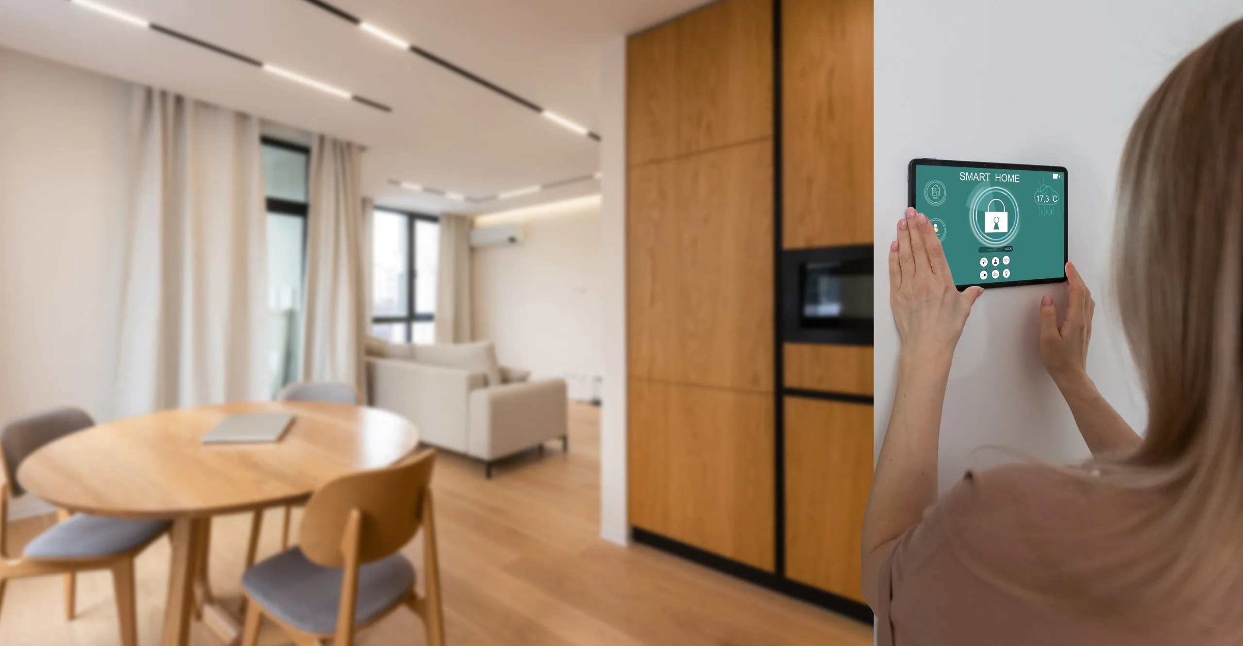 A person uses a smart home control panel for home security systems in Winnipeg