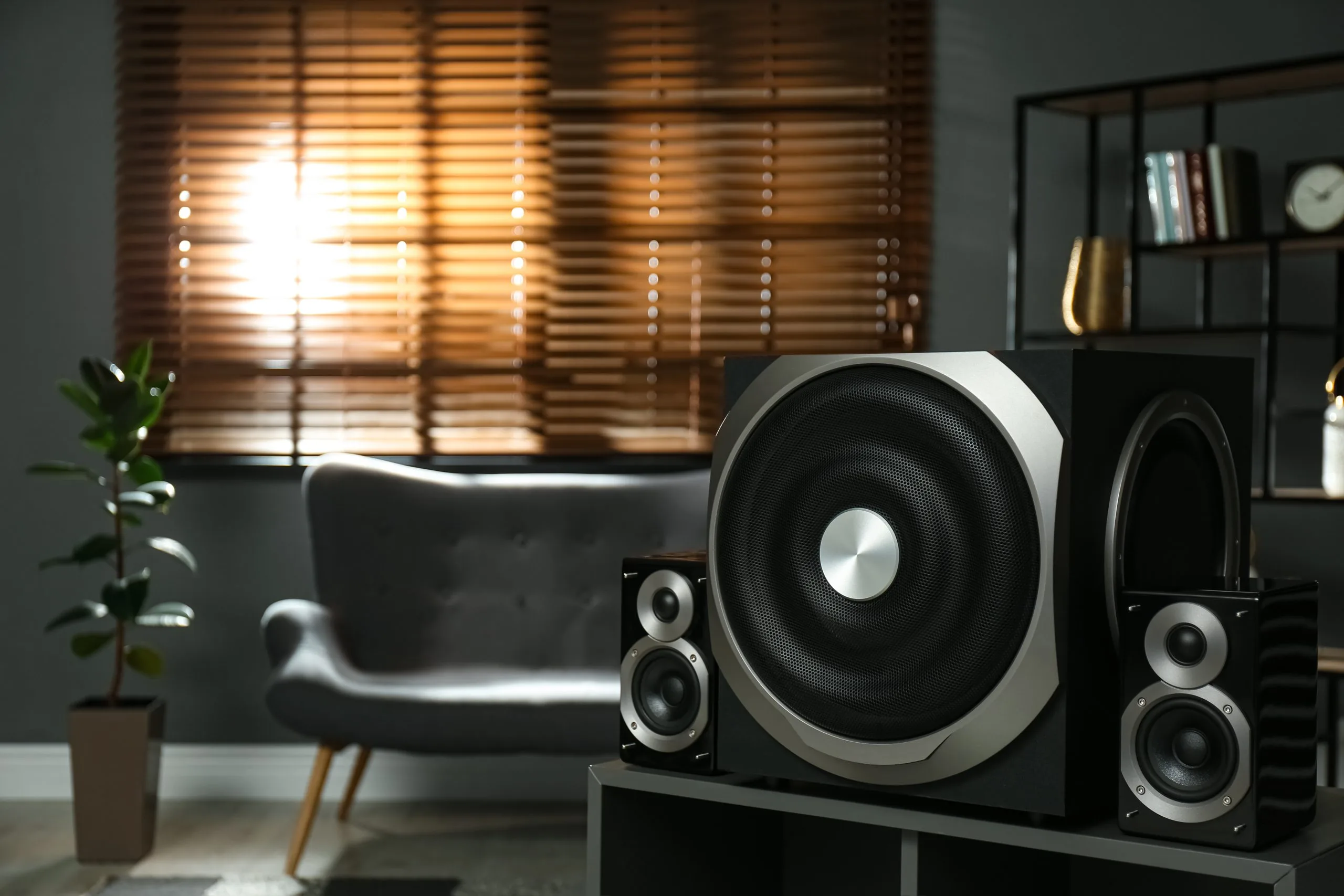 A large speaker is positioned in a stylish, softly lit room with modern decor
